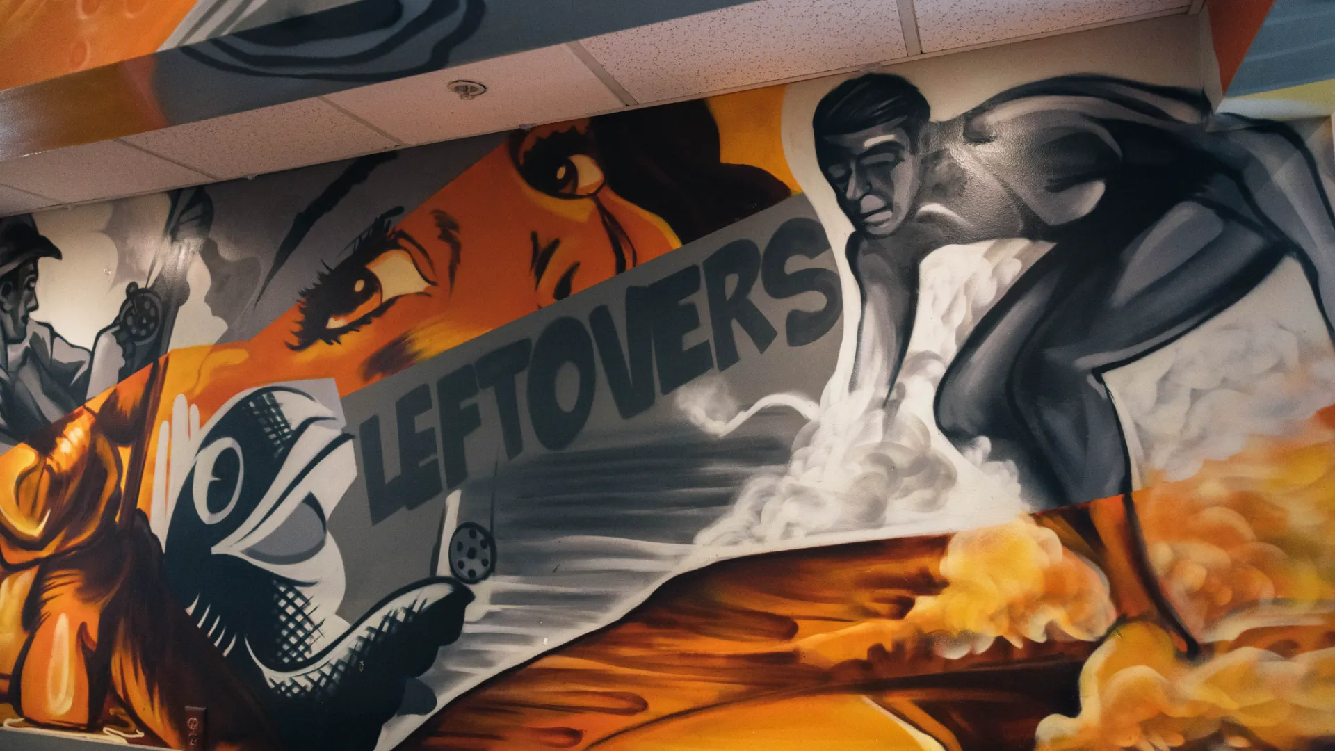 Mural on inside of Leftovers restaurant with the word Leftovers and a surfer