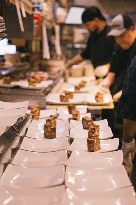 Chefs preparing plates of desserts