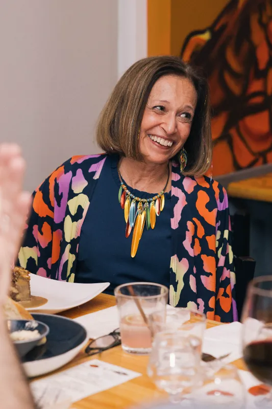Lady smiling sitting at a table