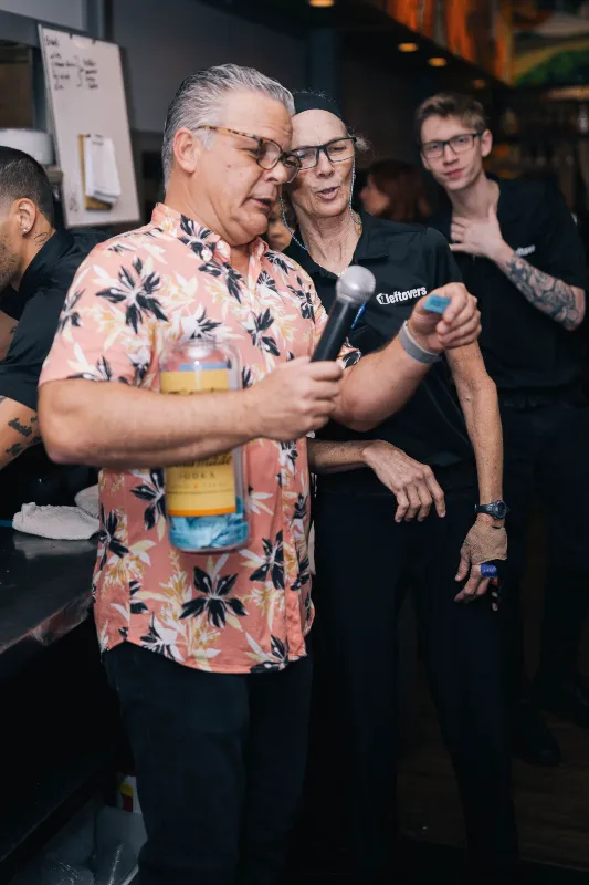 Man with microphone reading the name of lucky draw price